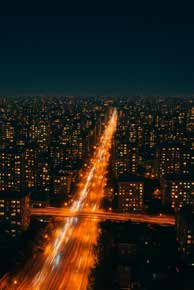 An illuminated city and road after dark.